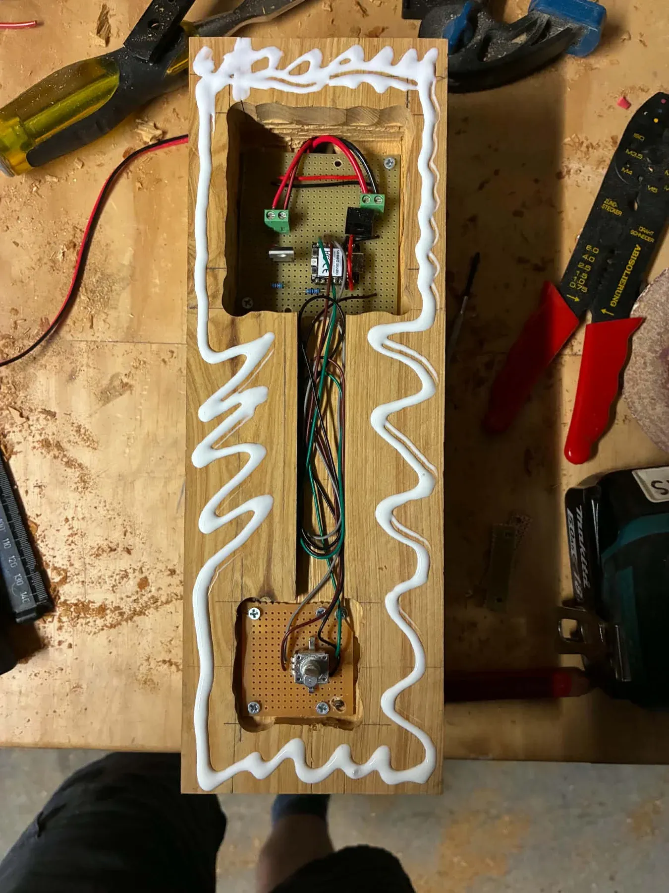 Open timber assembly on a workbench with the controller, encoder and connecting wires visible