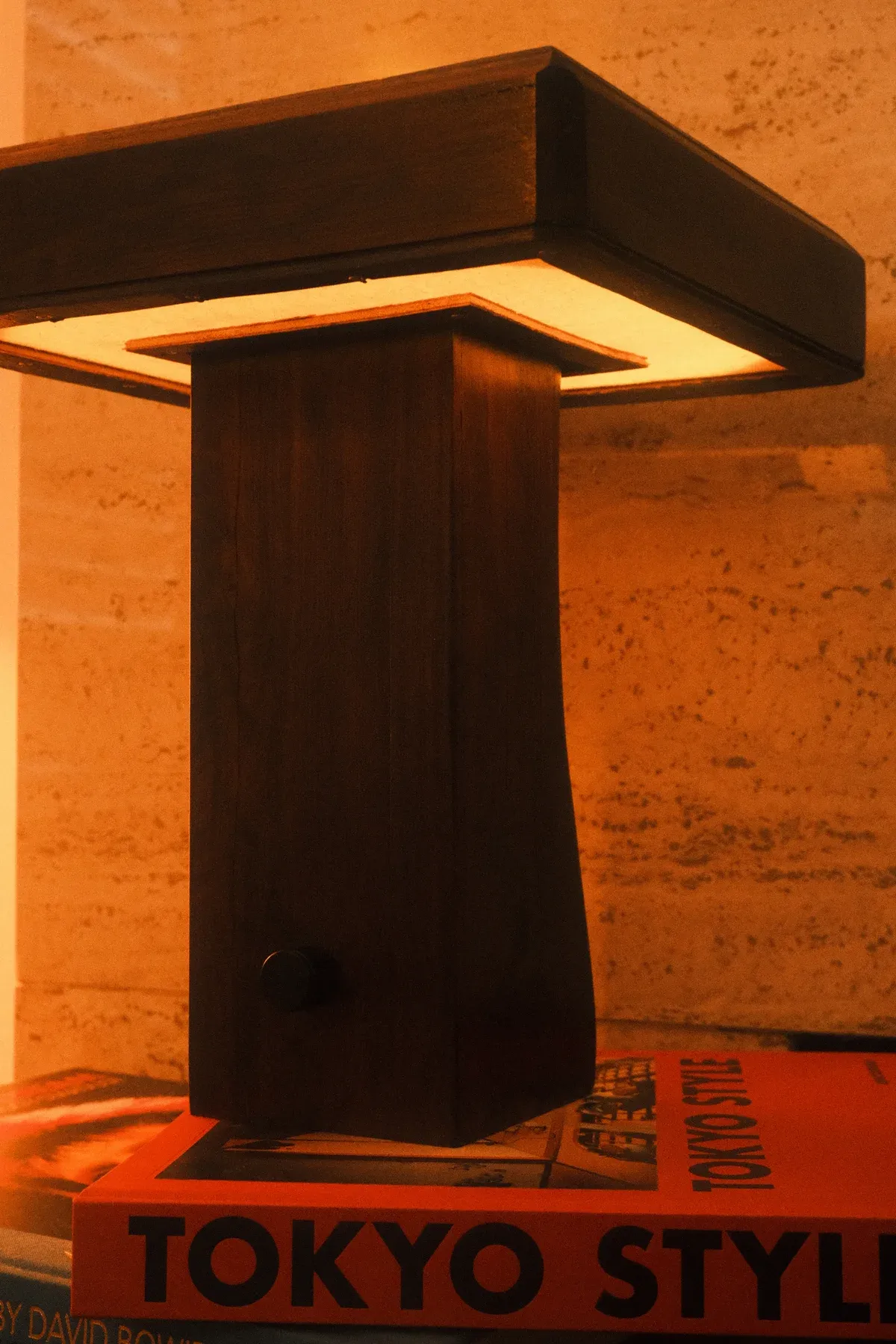 Warm light shining from the underside of the timber lamp head